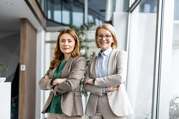 istock Two businesswomen smiling with confidence in modern office 2234470737