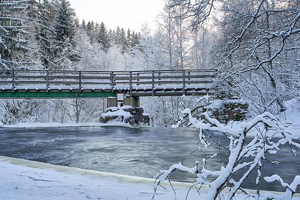 istock Winter bridge over a snowy river. 2234471142