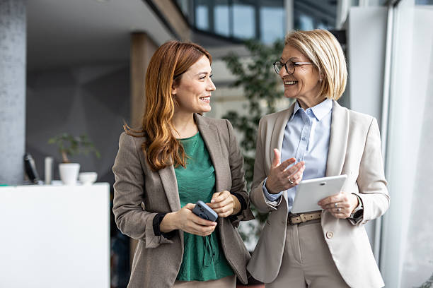 istock Two businesswomen collaborating and discussing work in modern office 2234471418