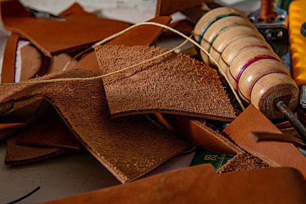 istock Close-up of artisan crafting handmade leather wallet in workshop 2234473031