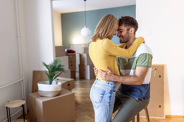 istock Young couple embraces while moving into their new apartment 2234474005