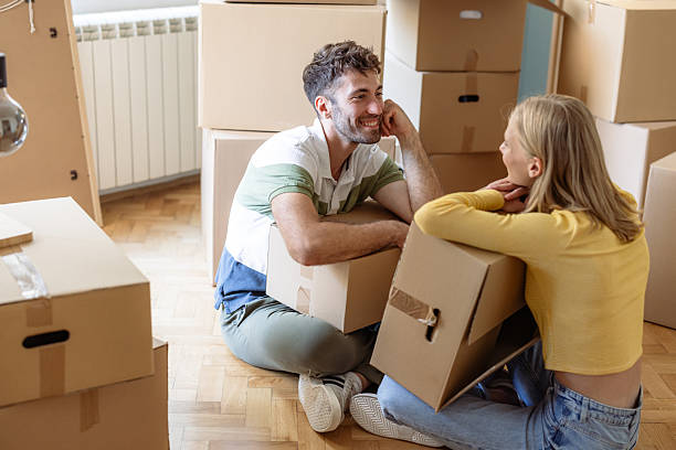 istock Young couple unpacking boxes while moving into their bright new apartment 2234474242