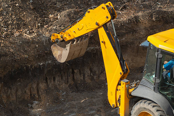 istock Excavator bucket above dug foundation pit at construction site close-up, foundation laying construction work, earthmoving with excavator. 2234475385