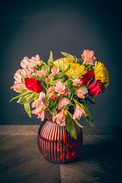 istock Flower Arrangement in Vase on Table With Black Background 2234475437