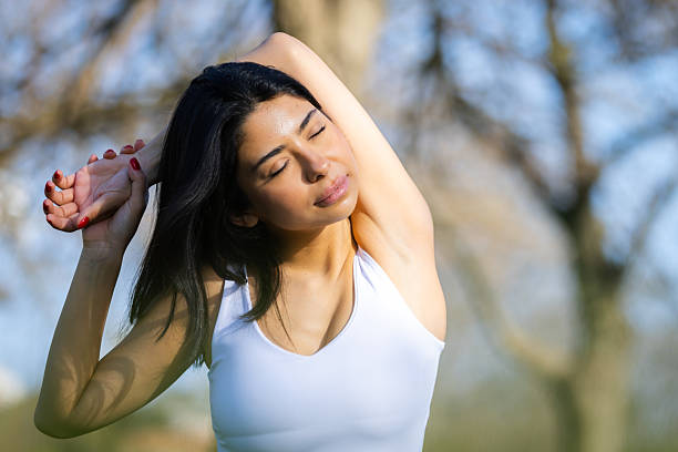 istock Young elegance woman is stretching in nature. 2234476142