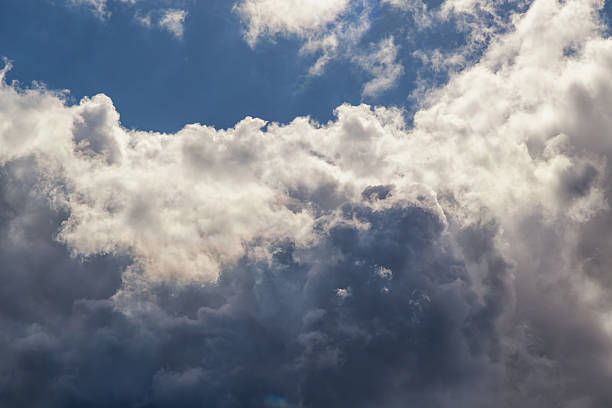 istock Sunlight falls from above on white cloud with pronounced texture close-up. 2234476302