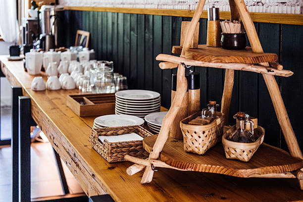 istock Rustic buffet table setup with plates, cups, glasses, and wooden condiment display emphasizing cozy dining and functional design 2234477470