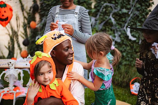 istock Father and daughters enjoying Halloween party in backyard 2234477948