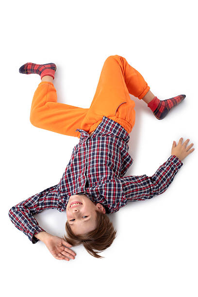A teenage boy walks eccentrically. He is depicted with his head down.