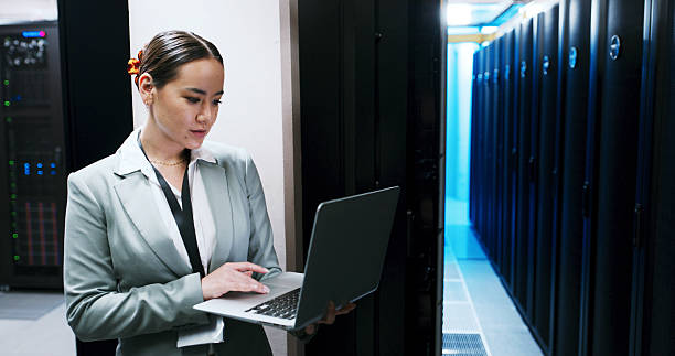 istock Administration, laptop and woman in server room for cybersecurity, network maintenance or programming. Computer, firewall installation and typing with IT professional in data center for engineering 2234480219