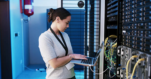 istock Woman, laptop and system test in server room, scroll and programming job for IT solution at company. Person, cybersecurity and assessment with coding, hardware and information technology at agency 2234480805