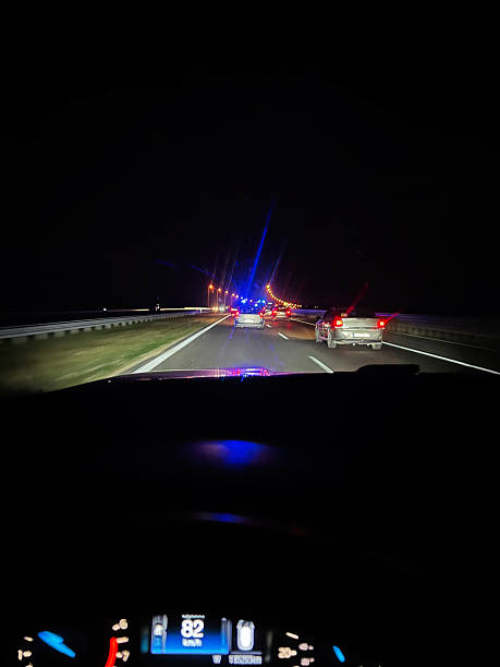 istock Night highway journey with vehicles and distant lights captured from inside a car 2234481836