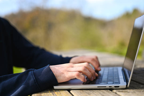 istock Freelancer working on laptop outdoors in nature 2234482931