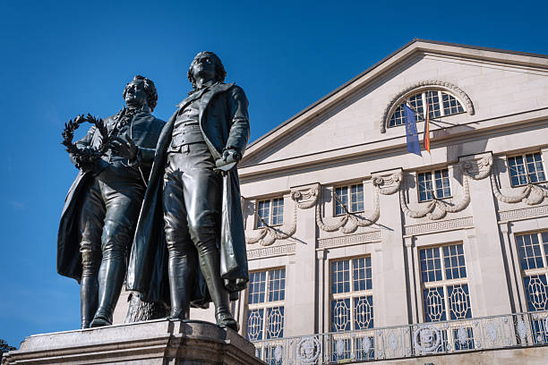 Classic view of famous Deutsches Nationaltheater with Goethe-Schiller monument on a beautiful sunny day with blue sky in Weimar, Thuringia, Germany