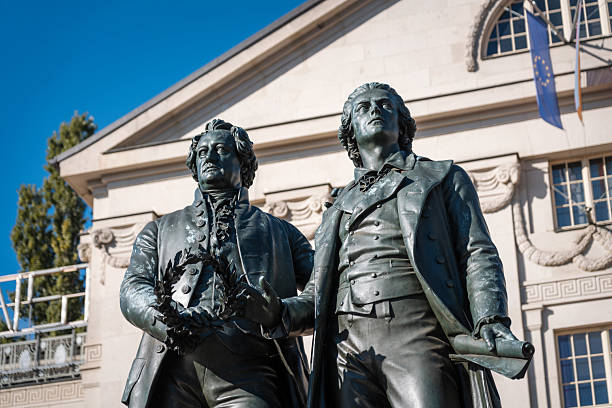 Classic view of famous Deutsches Nationaltheater with Goethe-Schiller monument on a beautiful sunny day with blue sky in Weimar, Thuringia, Germany