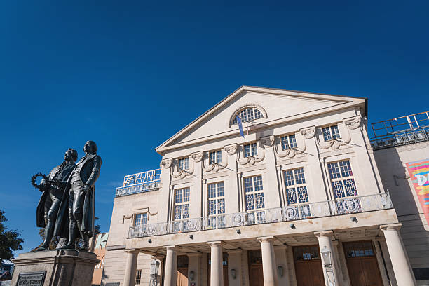 Classic view of famous Deutsches Nationaltheater with Goethe-Schiller monument on a beautiful sunny day with blue sky in Weimar, Thuringia, Germany