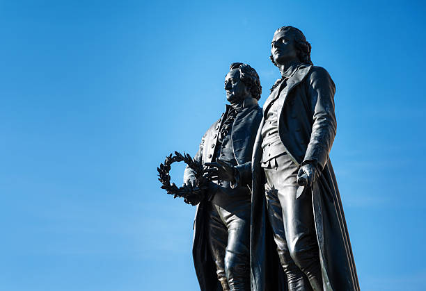 Classic view of famous Deutsches Nationaltheater with Goethe-Schiller monument on a beautiful sunny day with blue sky in Weimar, Thuringia, Germany