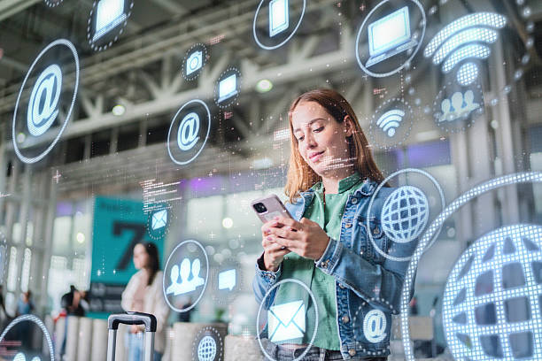 Mid adult woman using mobile phone and looking data on augmented reality at airport