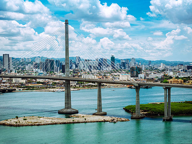 Scenic view of the Cebu City bridge, urban landscape, and the bay under a vibrant sky.