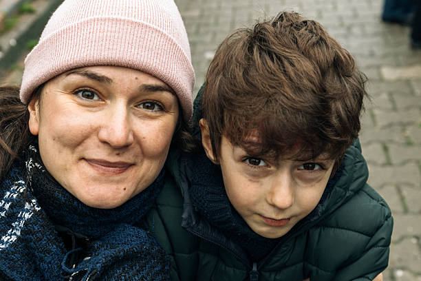 istock Mother and son with hat on a cold day 2234489249