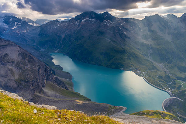 Mooserboden Staudamm in Austria beautiful alpine lakes stunning landscape. Austrian Alps in Salzburg region hiking trail scenic photo of two mountain lakes with turquoise water in the Alps from above Kaprun region