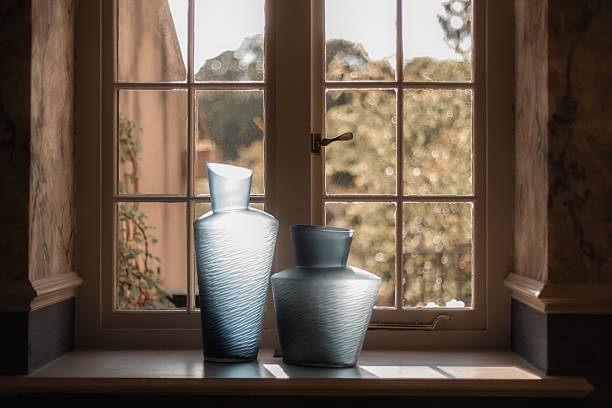 istock Two elegant vases on a window sill, bathed in soft natural light, dramatic light 2234491007