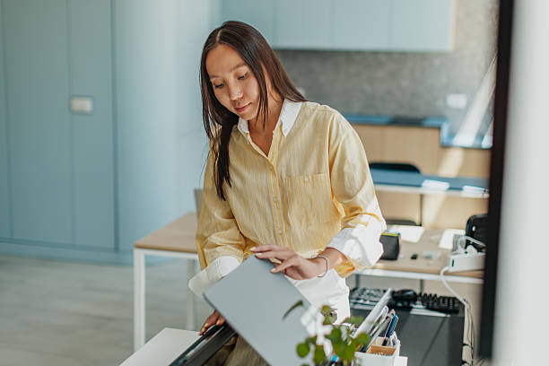 istock Asian woman working in a modern office with confidence and focus on a task 2234491131