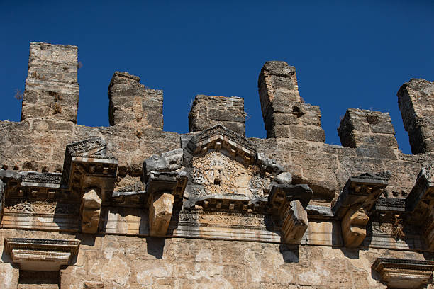 Ancient stone wall features intricate details.