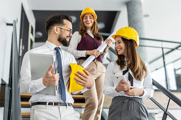 istock Architects talking and smiling on stairs in office building 2234491275