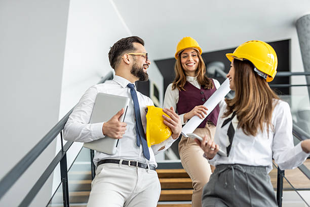 istock Architects and engineers discussing on stairs in office building 2234491298