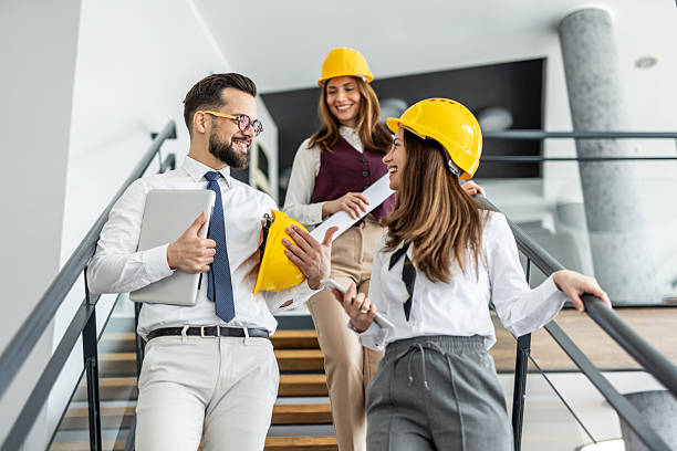 istock Architects walking and talking on stairs in modern office building 2234491299