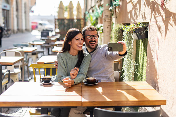 istock Happy couple taking a selfie while having coffee at outdoor cafe 2234495093