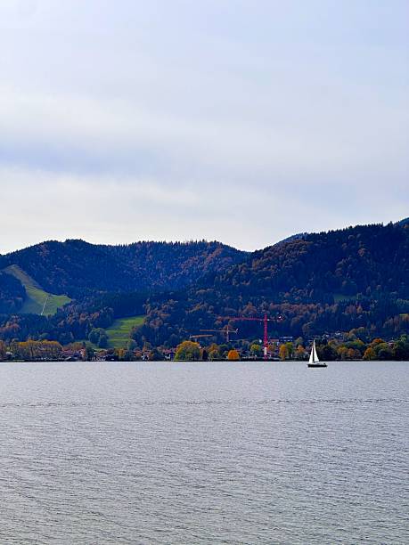 istock A mountain forest behind a lake with a lonely sailboat 2234495295
