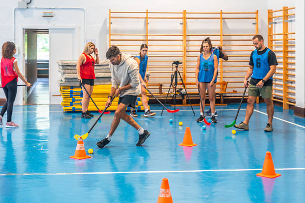 istock Athletes playing floorball in a gym 2234495468
