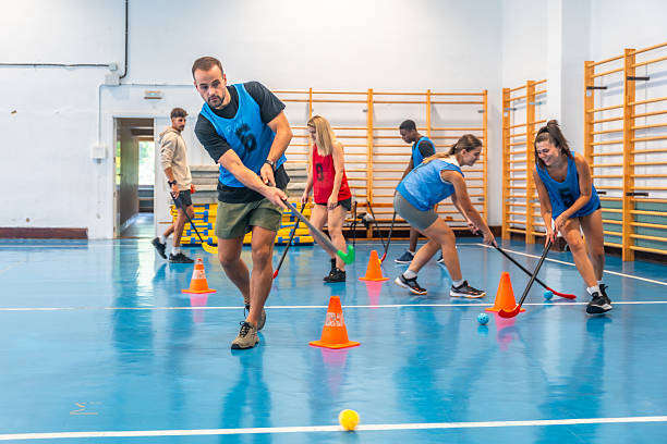 istock Athletes playing floorball in a gym during training session 2234495494