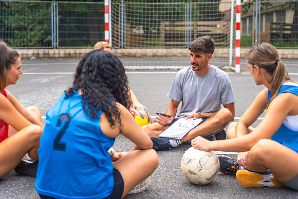 istock Soccer coach explaining game strategy to female team during training 2234495689