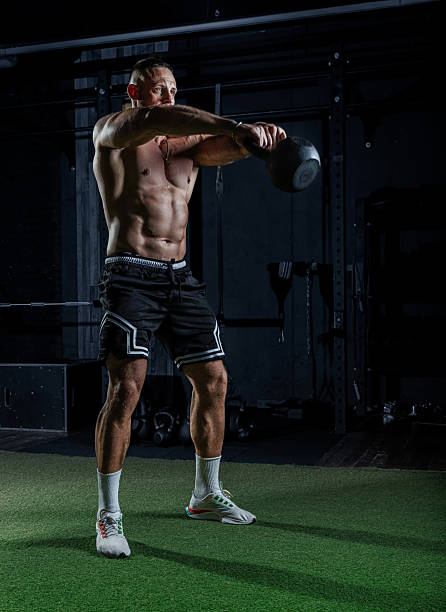 istock Muscular man having training with weights. Strong athletic man does workout. Concept bodybuilder doing exercises in gym. 2234496522