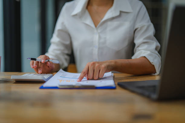 istock Businesswoman analyzing financial charts and calculating data with a calculator at her organized workplace, focused on strategic planning 2234496793