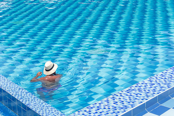 swimming pool of a resort with umbrellas and tables. relaxation and vacation