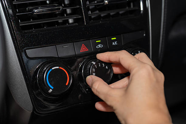 istock Hand adjusting car air conditioning knob to power level 1 2234497146