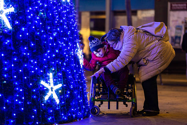 istock Disabled child enjoying christmas lights with mother 2234497770