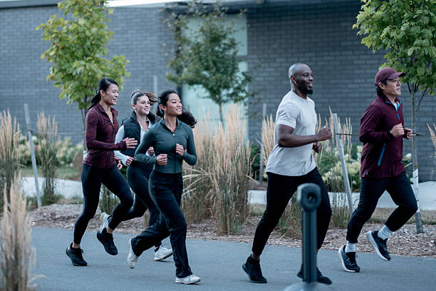 istock Group of Diverse Individuals Jogging Outdoors Together in a Community Setting 2234498497