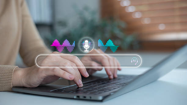 istock Hands typing on a laptop with a voice search interface, a microphone icon, and a sound wave hologram, concept of AI assistant, digital technology, online search, and smart innovation. 2234498655