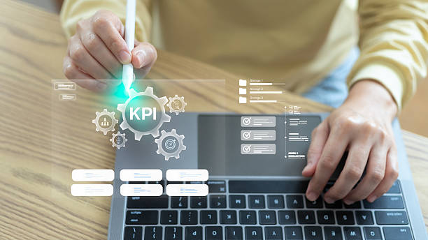 istock Close-up of a hand using a digital pen on a laptop with a hologram interface showing KPI, business performance metrics, data analytics, and a management dashboard for strategic planning. 2234499120