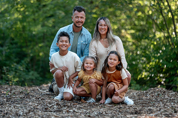 istock Happy Family Posing Outdoors in a Natural Forest Setting 2234502900