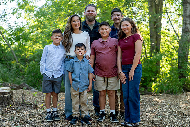 istock Smiling Family Posing Outdoors in Nature on a Sunny Day 2234503063