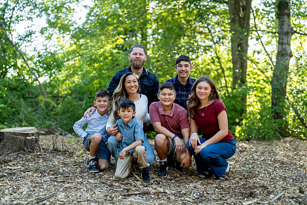 istock Happy Family Portrait Outdoors in a Sunny Forest Setting 2234503064