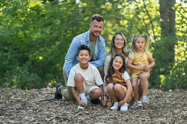 istock Smiling Family Posing Outdoors in a Forest Setting Together 2234503087