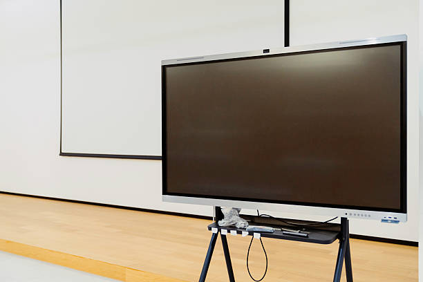 Modern classroom with an interactive whiteboard and notebook computers for each student.Similar images: