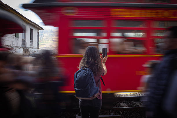 Teenage girl travelling by train. The girl is walking on platform at train station with a little suitcase.Vernazza train station in Cinque Terre, Italy.Nikon D850